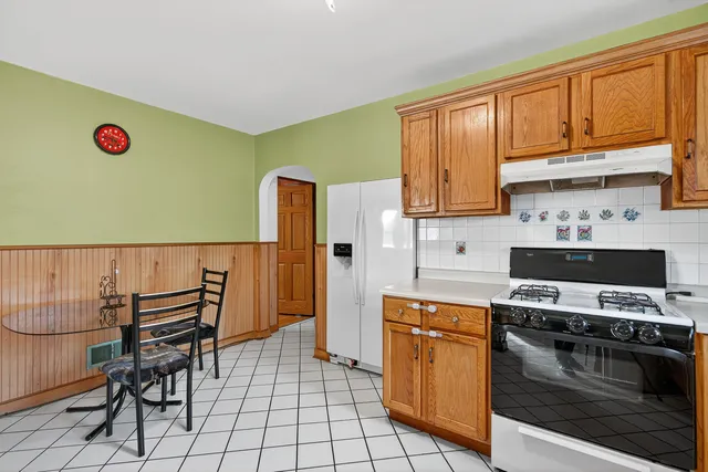 a kitchen with granite countertop a stove and a refrigerator