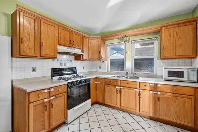 a kitchen with cabinets appliances and a window
