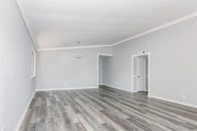 a view of room with wooden floor