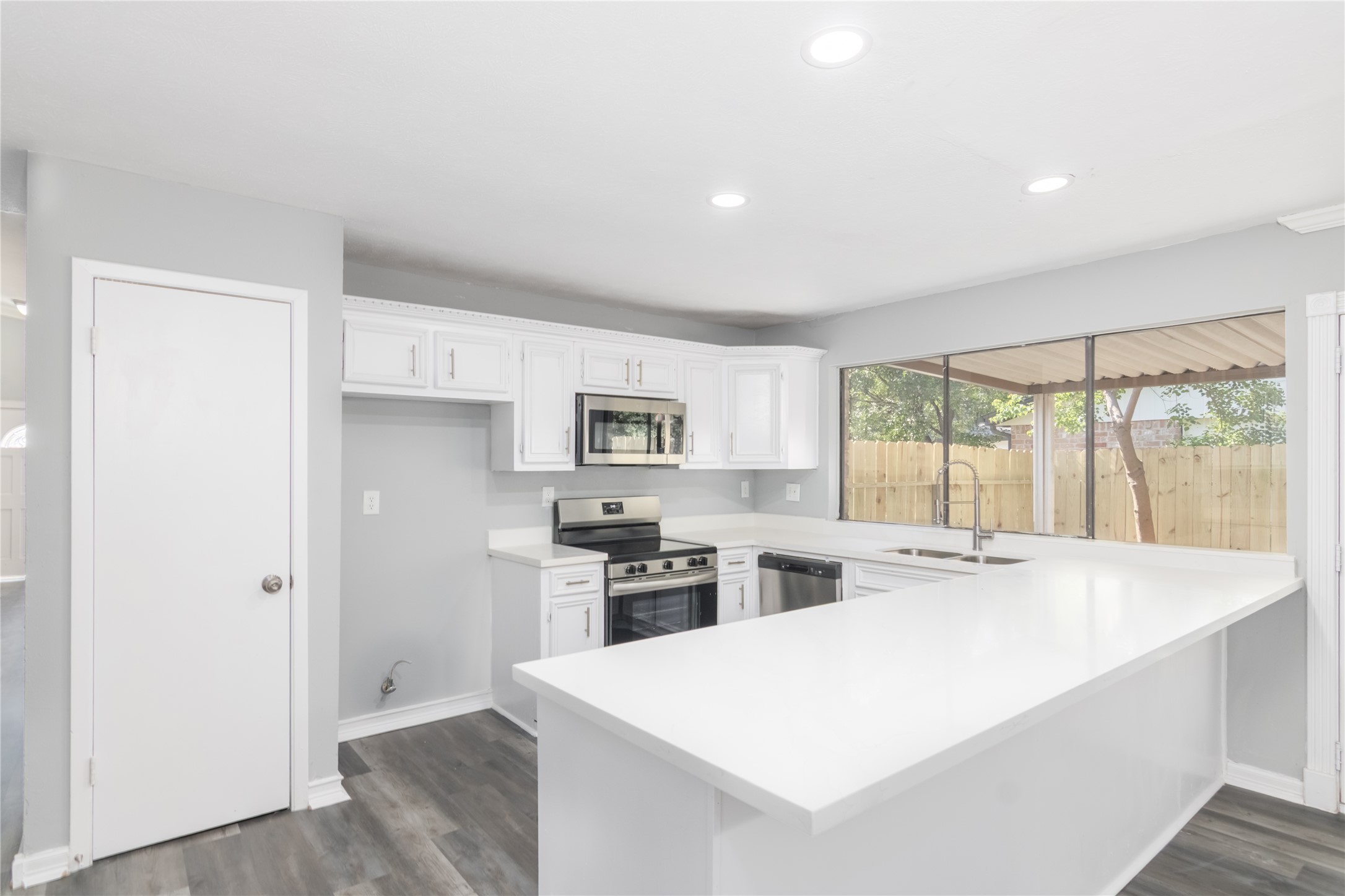 22914 Summer Pine Lane Spring, TX 77373 - Photo 6 of 19 a large white kitchen with a stove a sink and dishwasher