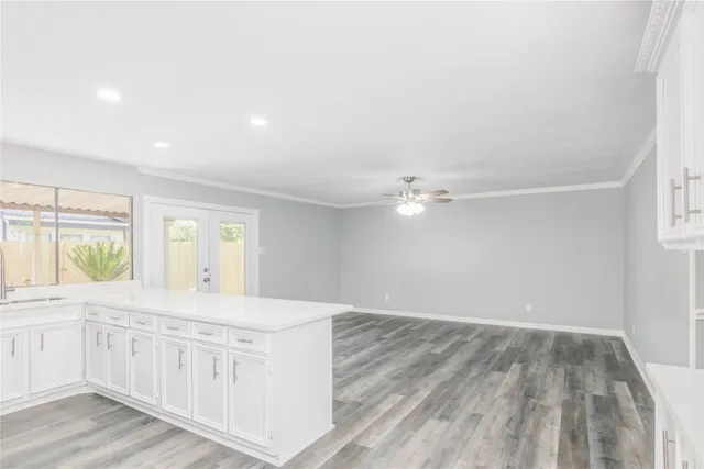 a view of a kitchen cabinets a sink and wooden floor