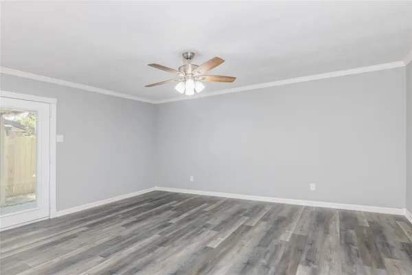 wooden floor in an empty room with a window