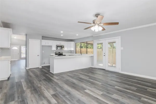 a view of a kitchen with wooden floor and a kitchen