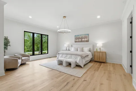 a bedroom with a bed and a chandelier