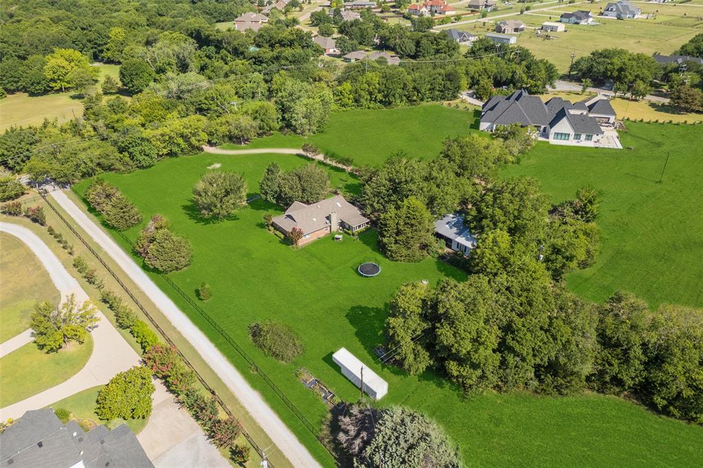 1980 Winningkoff Road Lucas, TX 75002 - Photo 32 of 35 Expansive green property featuring multiple residences and extensive tree coverage