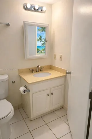 a bathroom with a sink toilet and mirror