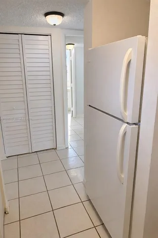 a white refrigerator freezer and a microwave in a kitchen