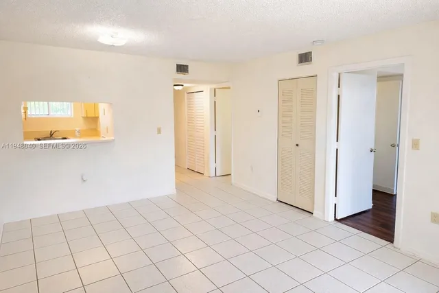 an empty room with windows and painted walls