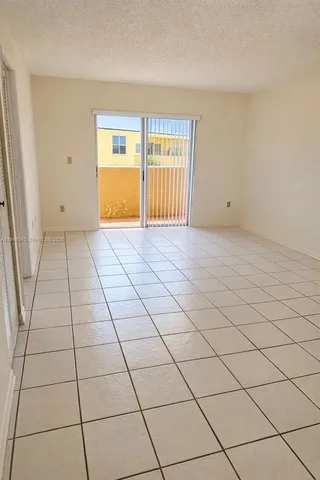 a view of an empty room and a window