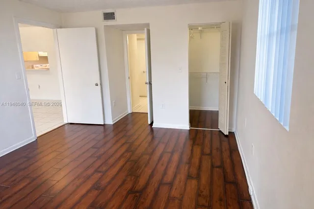 a view of a hallway with wooden floor