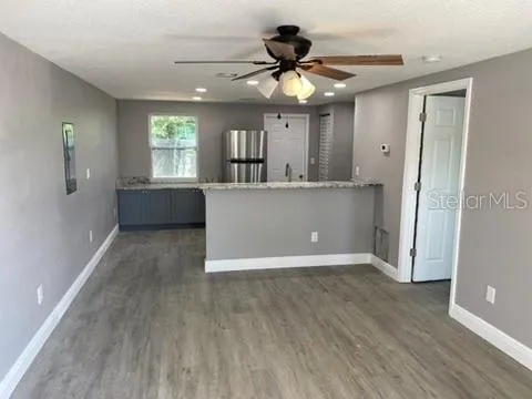 a kitchen with stainless steel appliances granite countertop a refrigerator and a sink
