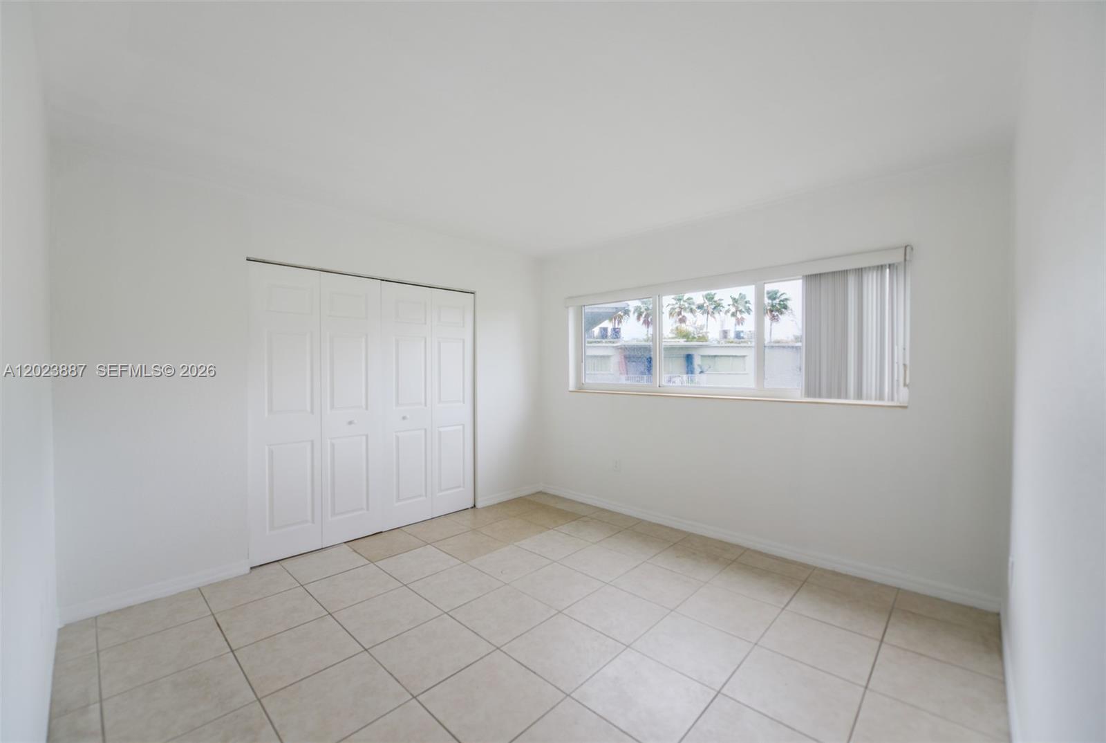 7737 Southwest 88th Street, Unit C312 Miami, FL 33156 - Photo 13 of 32 a view of an empty room with a window