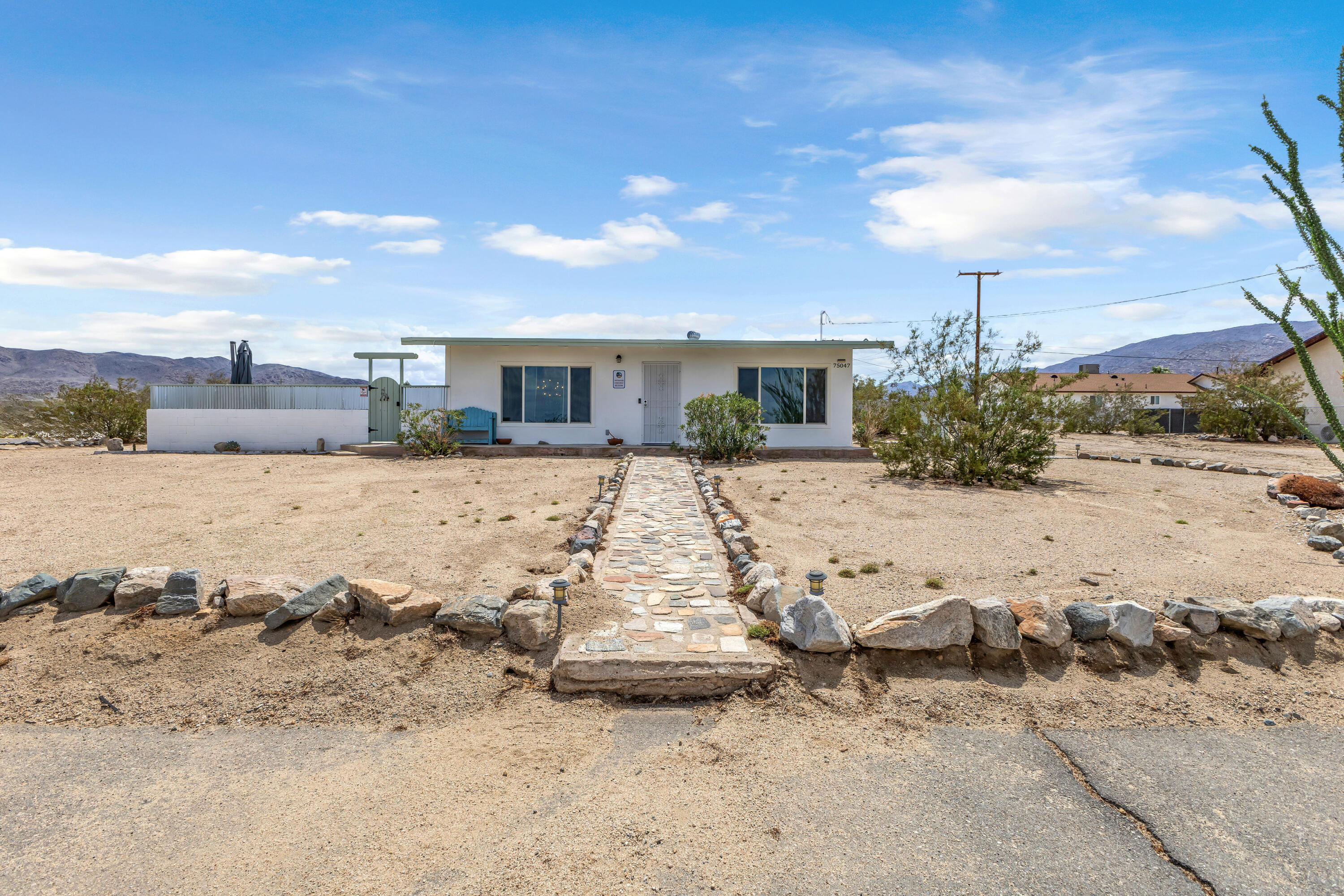 75047 Baseline Road Twentynine Palms, CA 92277 - Photo 1 of 47 a view of a dry yard with wooden fence