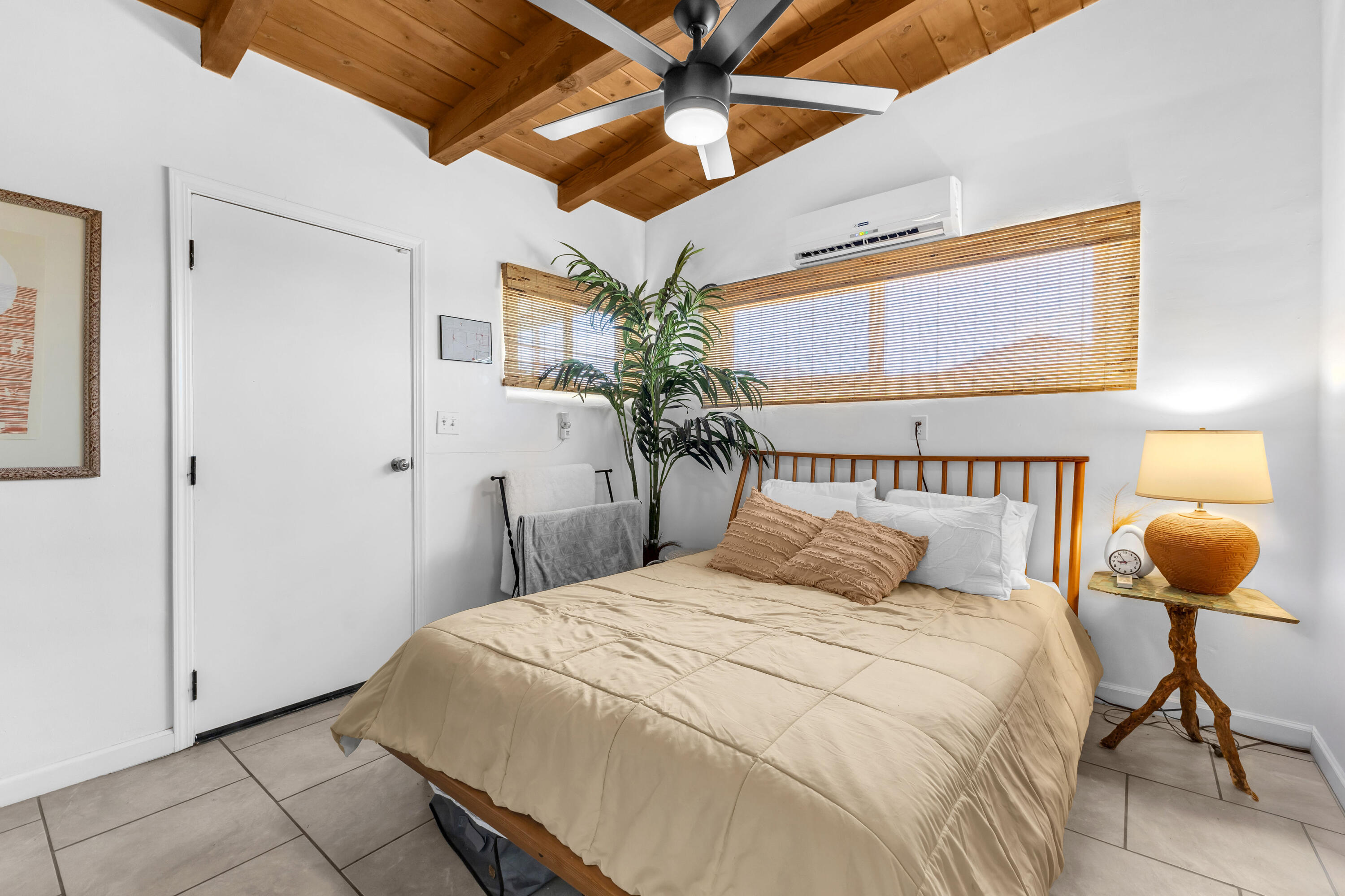 75047 Baseline Road Twentynine Palms, CA 92277 - Photo 12 of 47 a bedroom with a bed and a chandelier