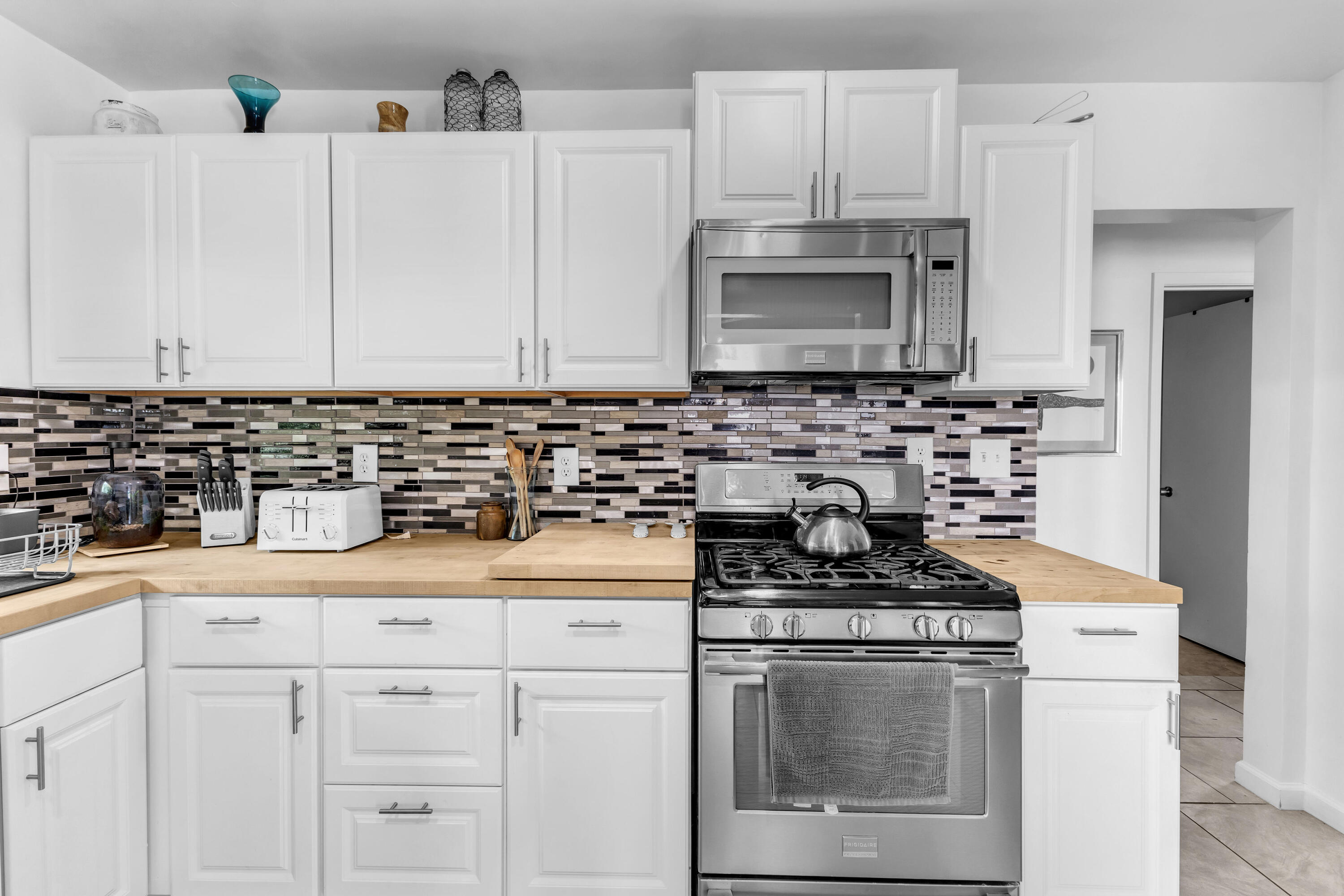 75047 Baseline Road Twentynine Palms, CA 92277 - Photo 16 of 47 a kitchen with white cabinets sink and white appliances