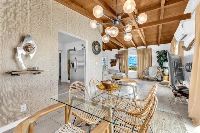 a view of a dining room with furniture and a chandelier