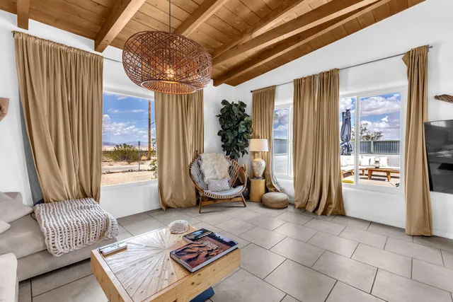 a living room with furniture and a floor to ceiling window