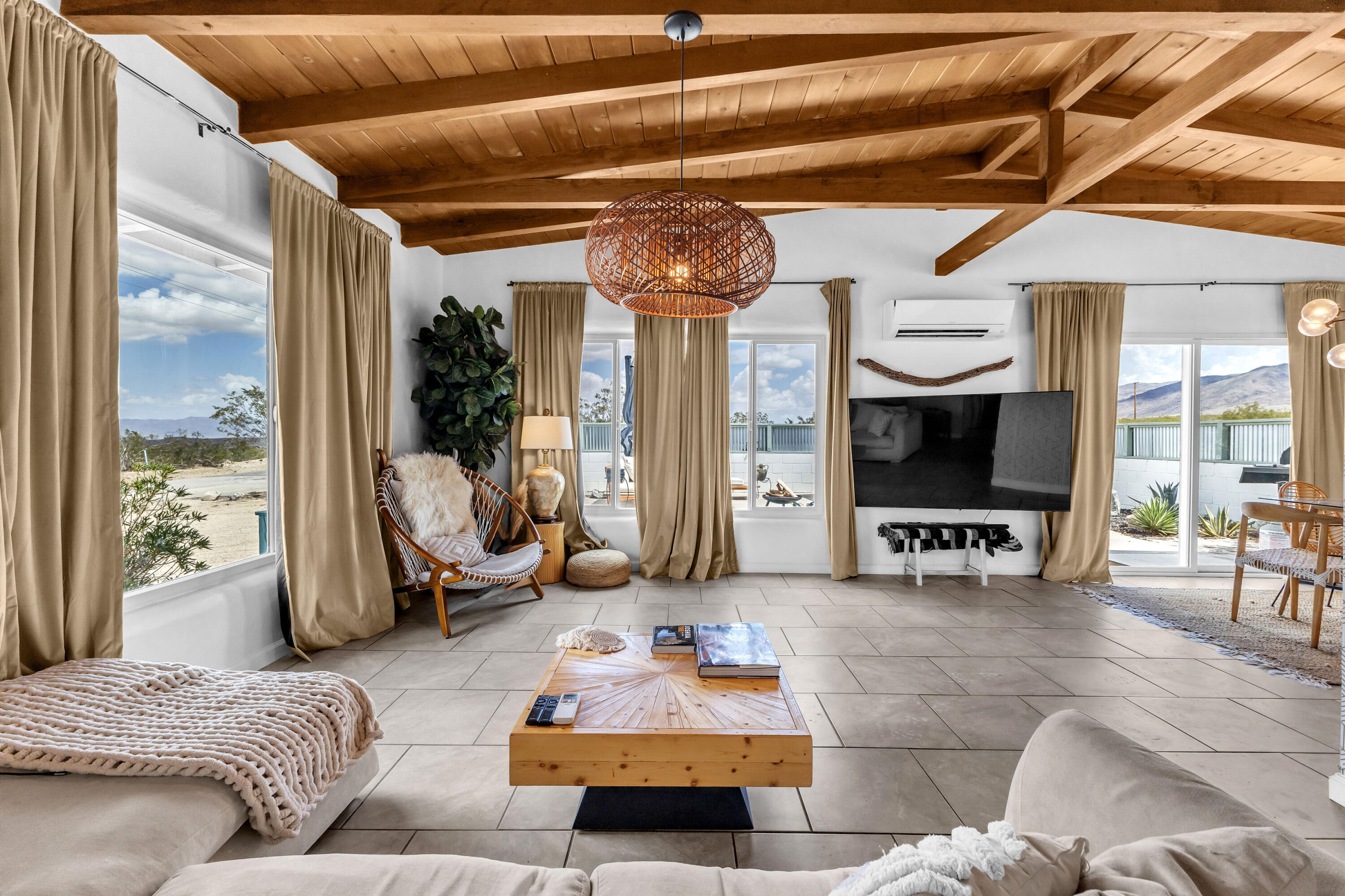 75047 Baseline Road Twentynine Palms, CA 92277 - Photo 27 of 47 a living room with furniture and a flat screen tv