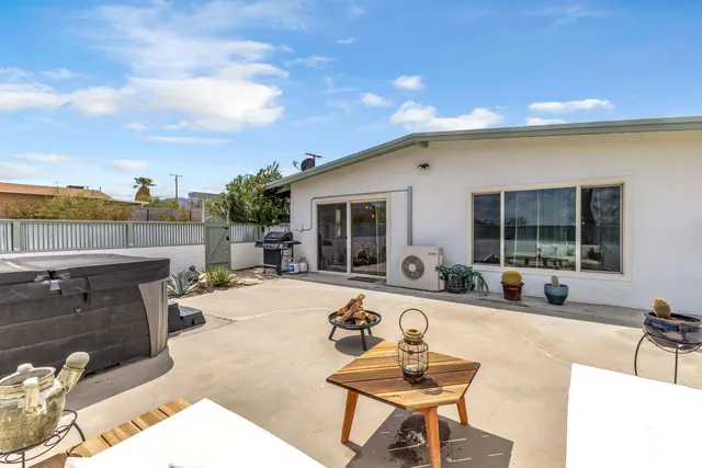 a swimming pool with outdoor seating and barbeque oven
