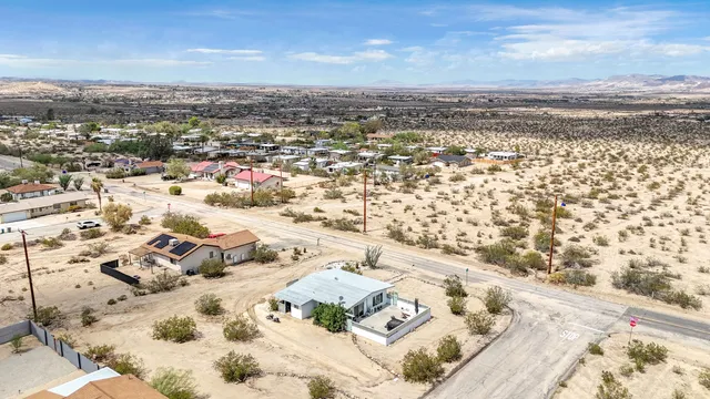 an aerial view of residential houses with outdoor space