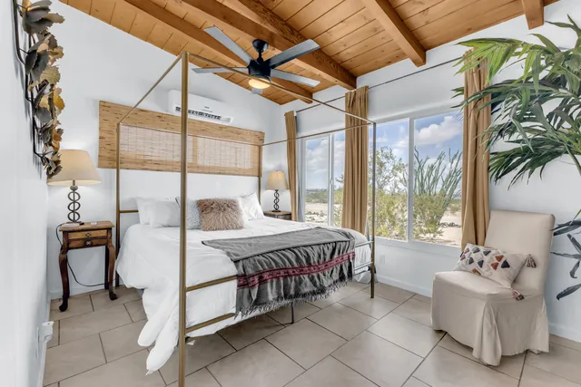 a bed sitting in a bedroom next to a window