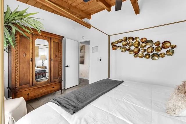 a bedroom with a large bed and a window