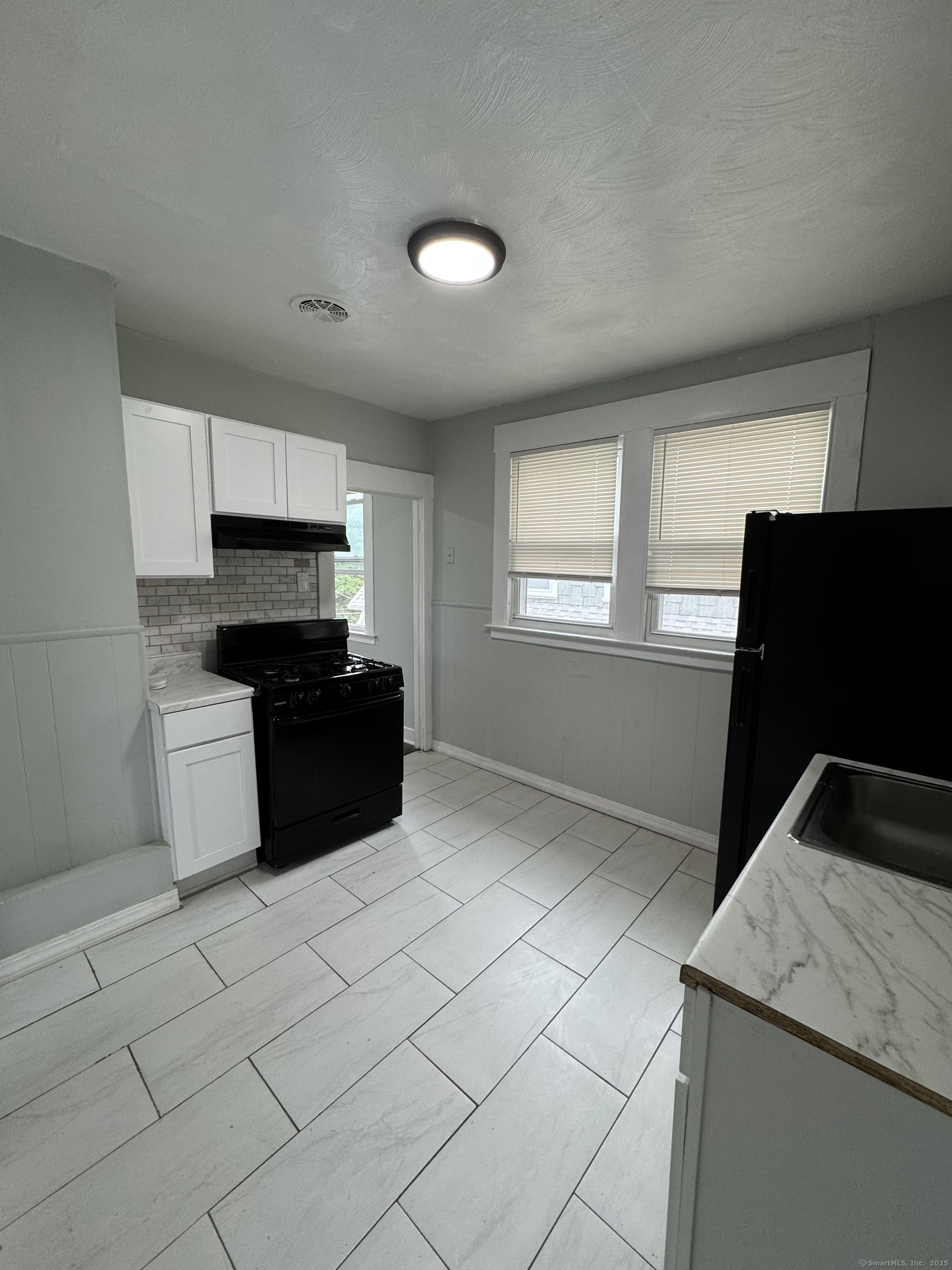 199 English Street, Unit 2 New Haven, CT 06513 - Photo 3 of 10 a kitchen with stainless steel appliances granite countertop a refrigerator and a sink