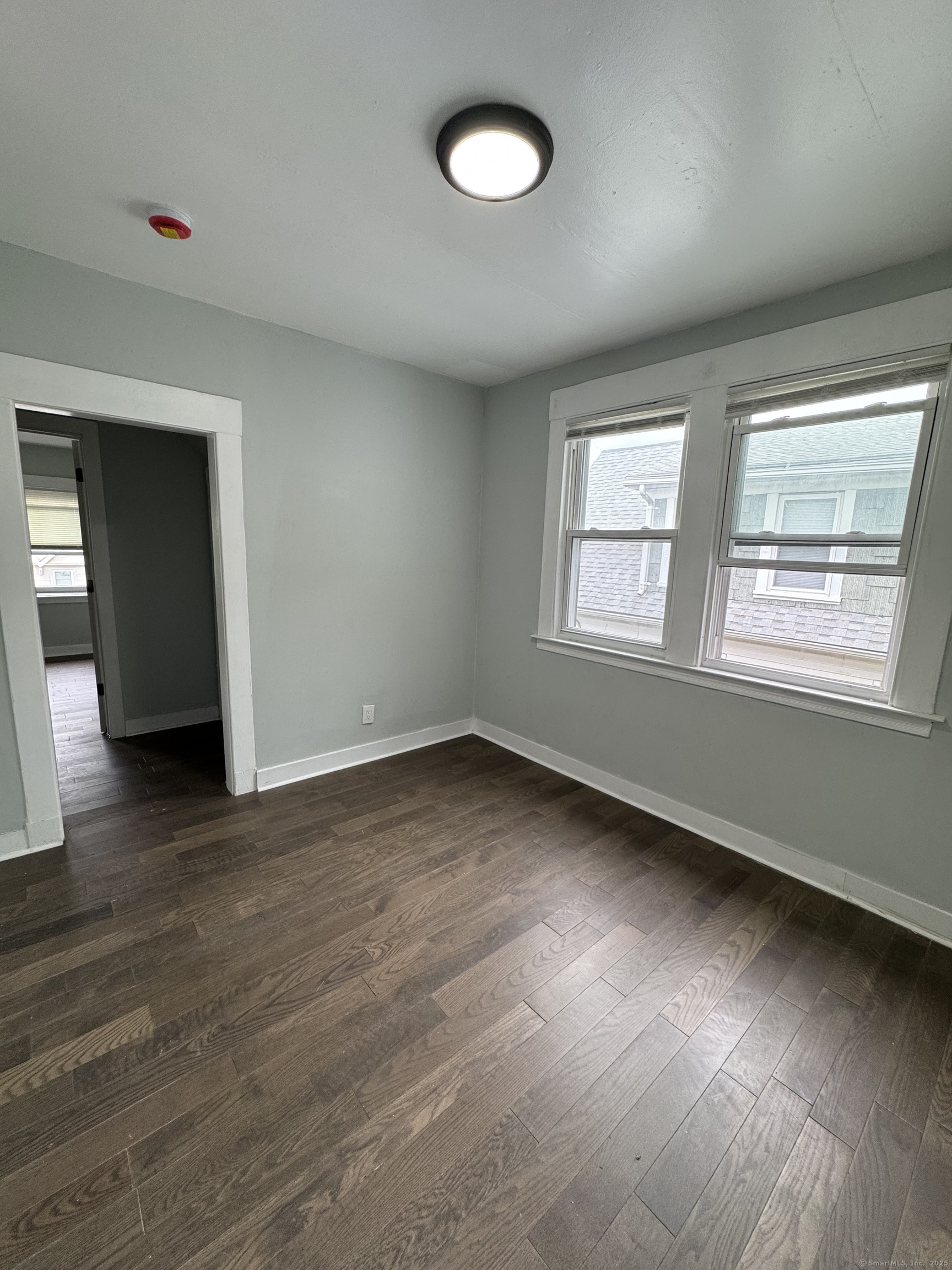 199 English Street, Unit 2 New Haven, CT 06513 - Photo 6 of 10 an empty room with wooden floor and windows