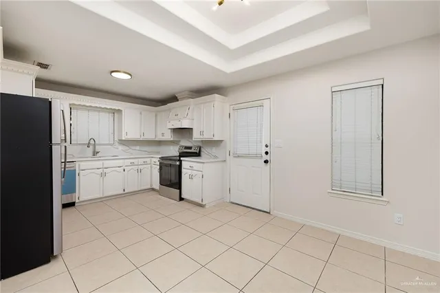 a kitchen with granite countertop a refrigerator and a sink