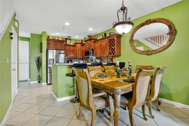 a dining room filled chandelier and a mirror