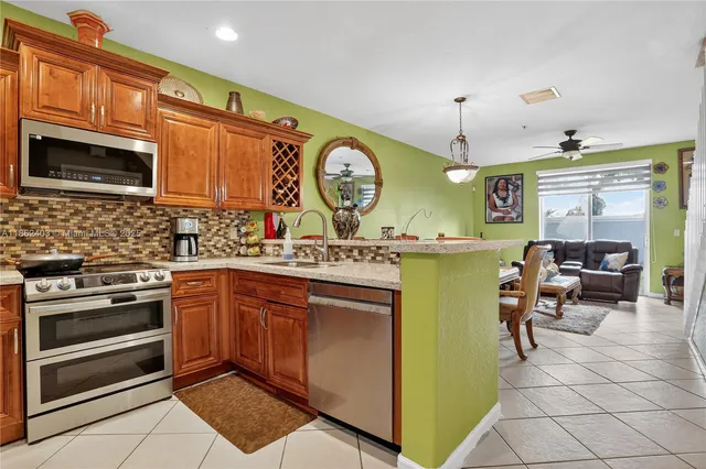 a kitchen with a stove a sink and a refrigerator