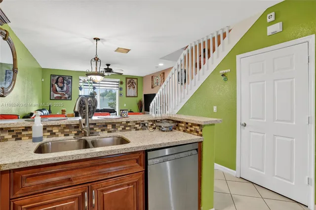 a view of a kitchen with a sink and a refrigerator