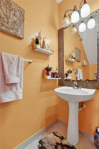 a bathroom with a sink mirror and vanity