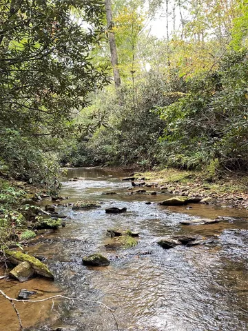 a view of dirt road with trees