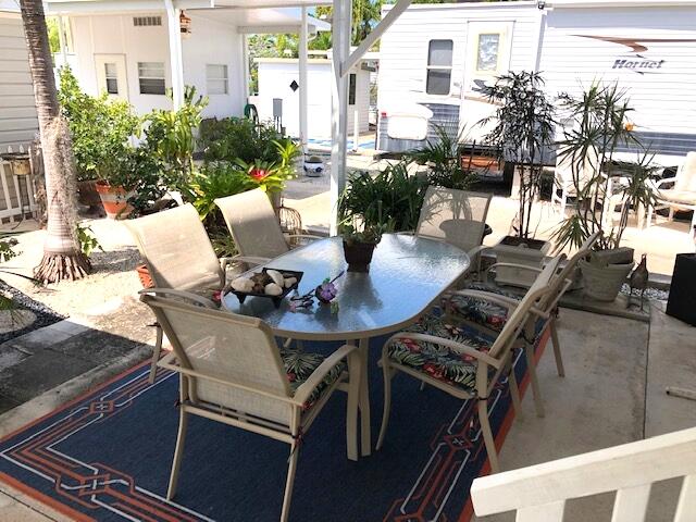 55 Boca Chica Road, Unit 32 Key West, FL 33040 - Photo 4 of 27 a view of a patio with table and chairs and potted plants
