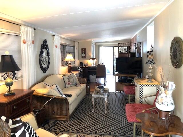 55 Boca Chica Road, Unit 32 Key West, FL 33040 - Photo 7 of 27 a living room with furniture a flat screen tv and a large window