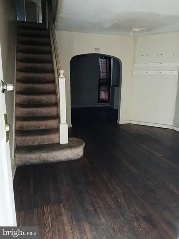 a kitchen with stainless steel appliances granite countertop a refrigerator a stove and a sink with wooden cabinets