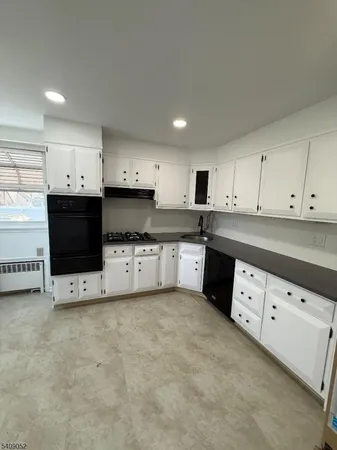 a kitchen with cabinets a sink and a stove