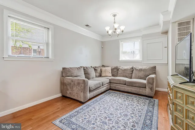 a living room with furniture and a chandelier