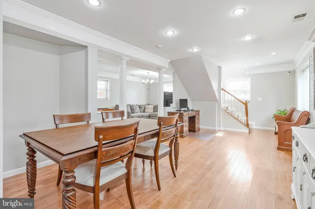 a dining room with furniture and wooden floor