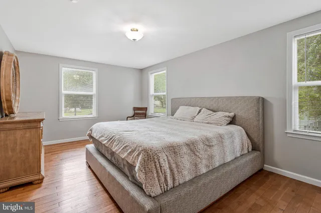 a large bed sitting in a bedroom next to a window