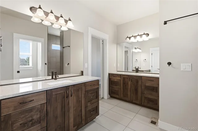 a bathroom with a double vanity sink and a mirror