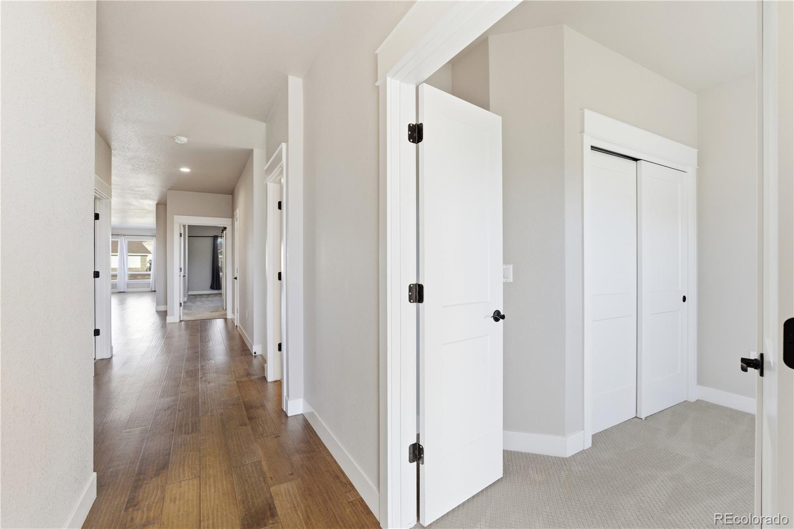 1908 Tidewater Lane Windsor, CO 80550 - Photo 16 of 41 a view of a hallway with wooden floor