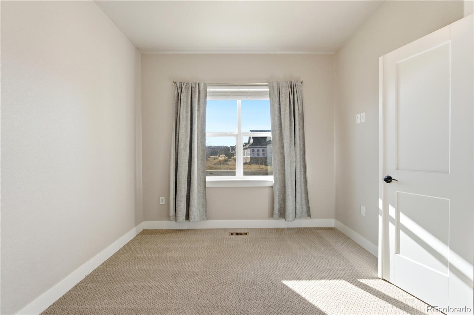 1908 Tidewater Lane Windsor, CO 80550 - Photo 17 of 41 an empty room with windows