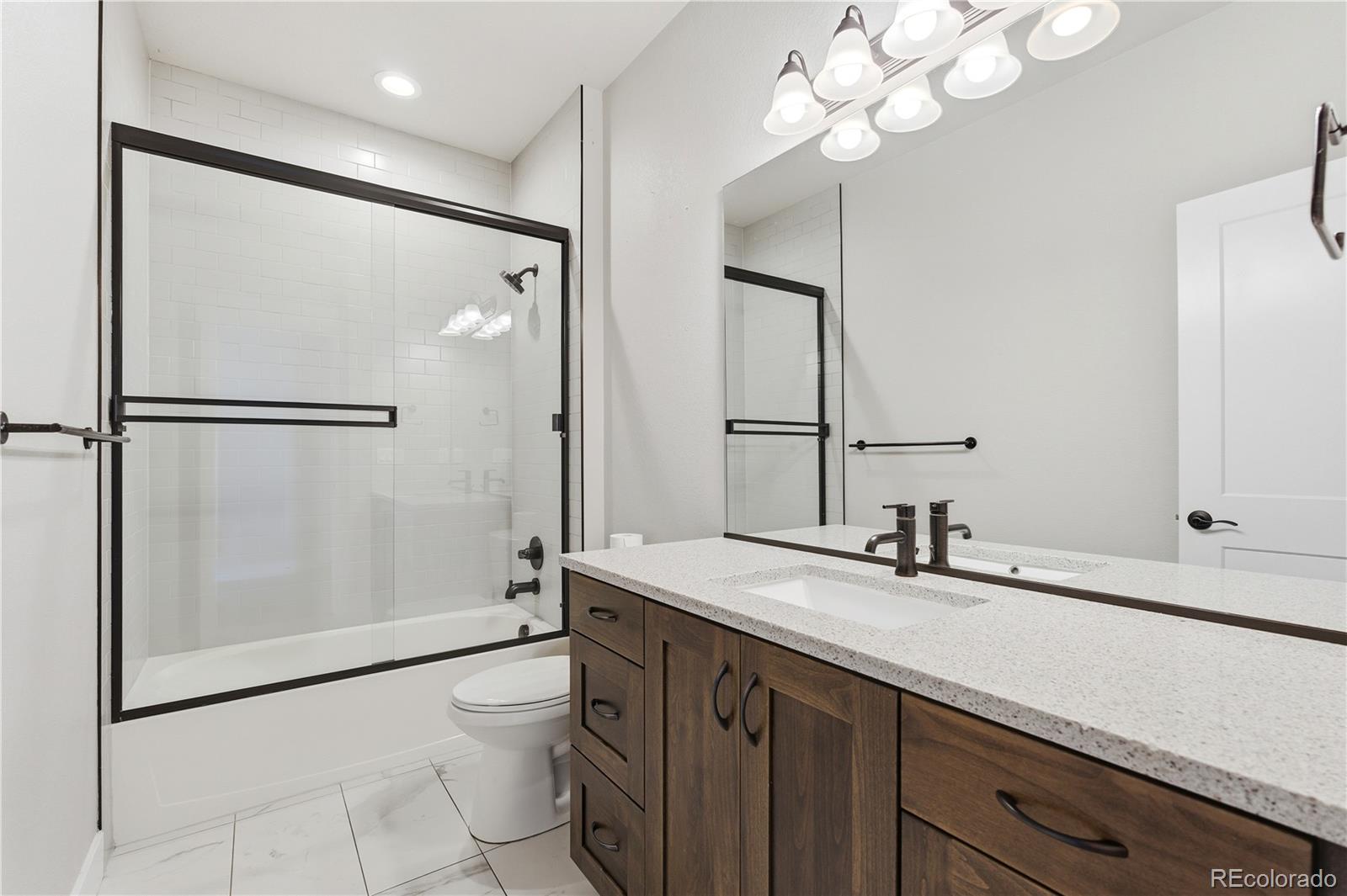1908 Tidewater Lane Windsor, CO 80550 - Photo 19 of 41 a bathroom with a double vanity sink mirror and toilet