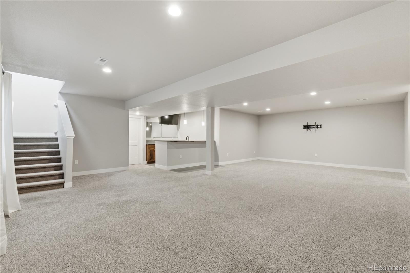 1908 Tidewater Lane Windsor, CO 80550 - Photo 21 of 41 an empty room with a kitchen and a sink