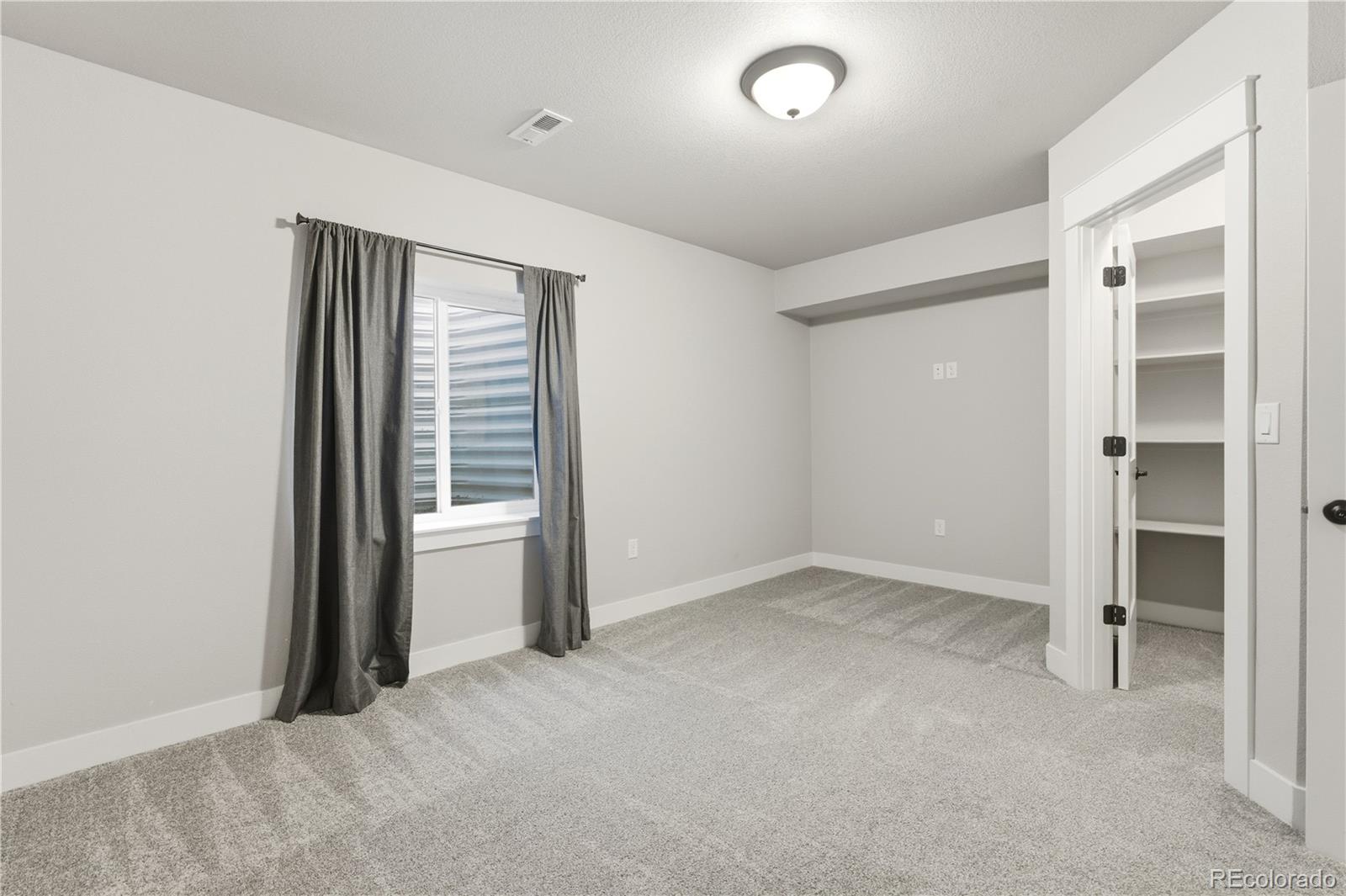1908 Tidewater Lane Windsor, CO 80550 - Photo 27 of 41 an empty room with closet and a window