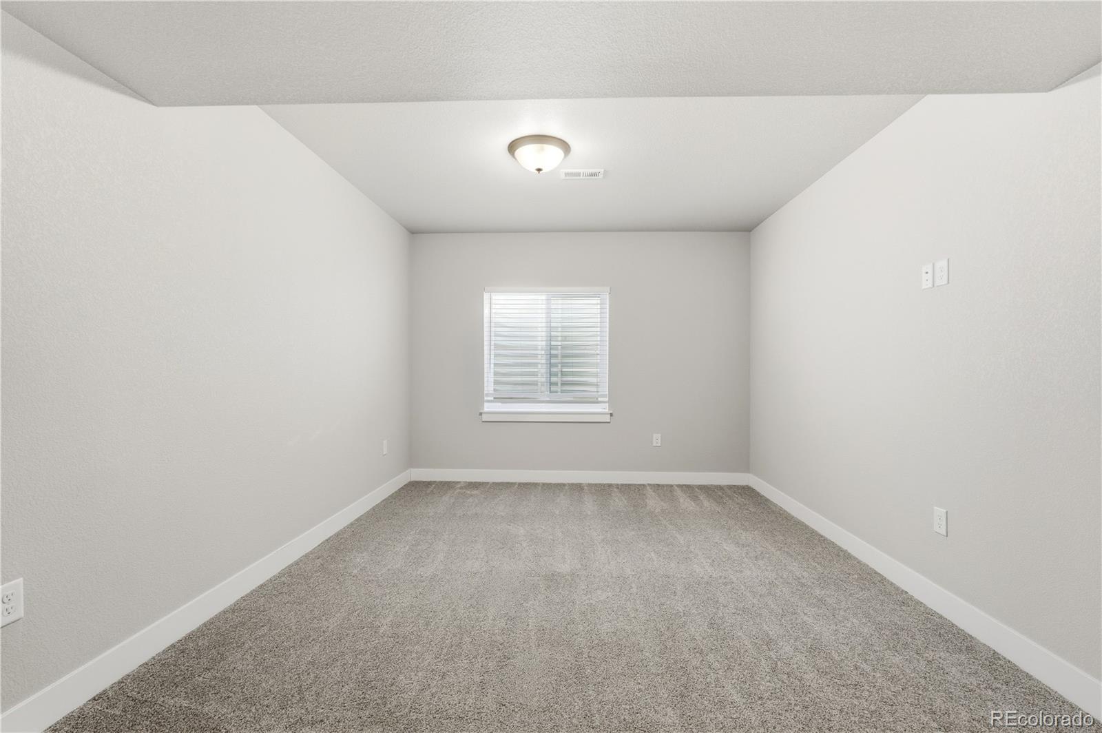1908 Tidewater Lane Windsor, CO 80550 - Photo 30 of 41 a view of an empty room with a window