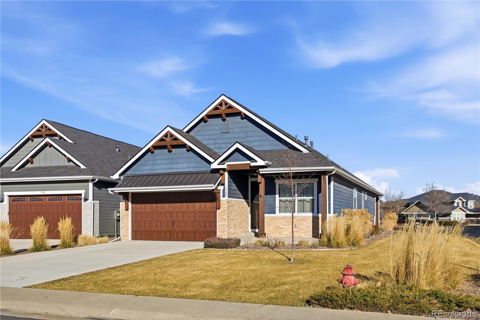 1908 Tidewater Lane Windsor, CO 80550 - Photo 35 of 41 a front view of a house with a garden and pathway