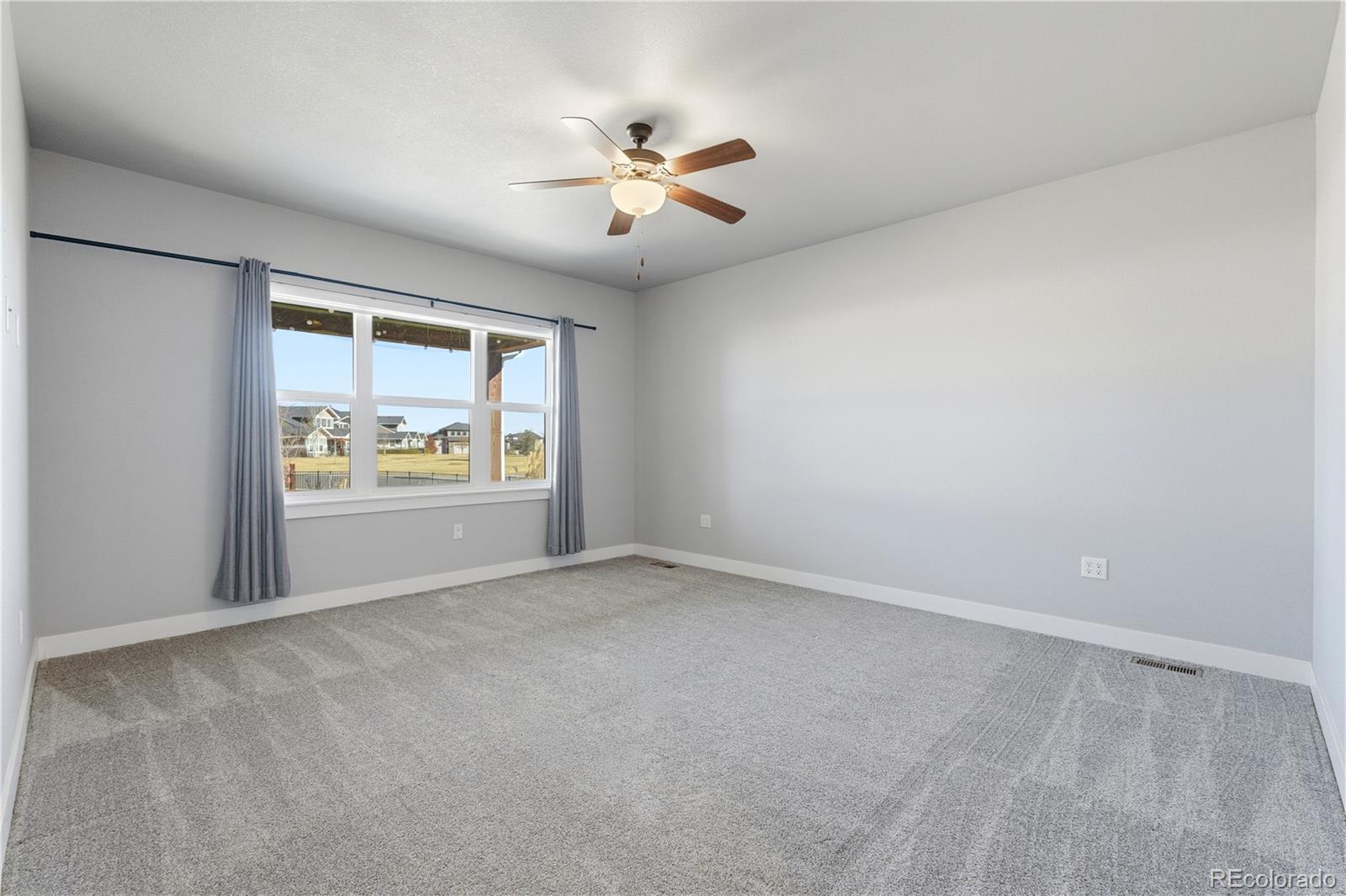 1908 Tidewater Lane Windsor, CO 80550 - Photo 10 of 41 a view of an empty room with a window